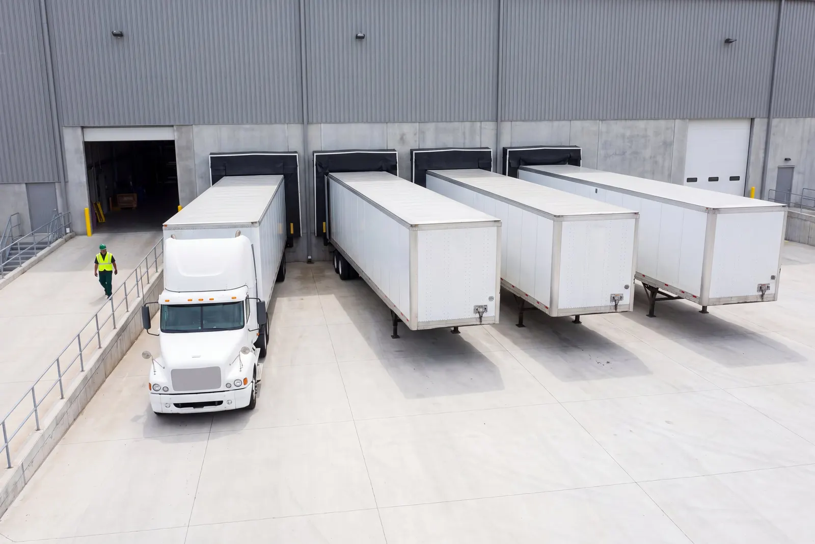 Trucks backed into the loading dock doors of a distribution center