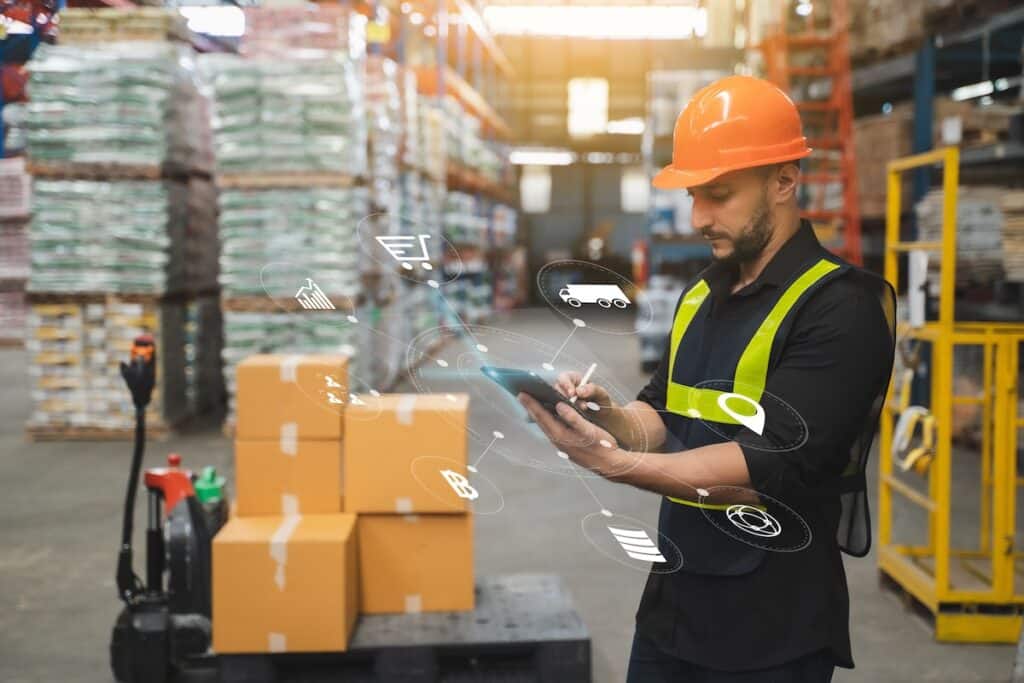 a worker using logistics management system software in a warehouse