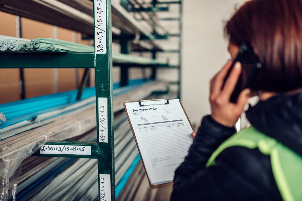 warehouse staff holding purchase order