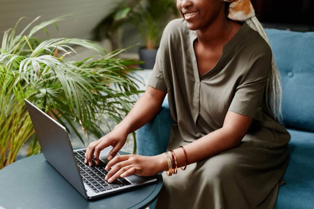 woman typing on a laptop at home