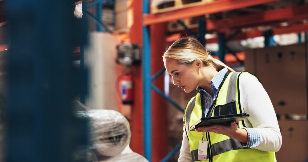 female warehouse worker conducting inventory count